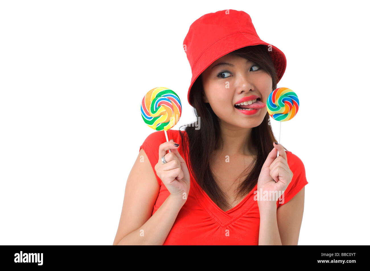 Young woman licking on lollipop Stock Photo