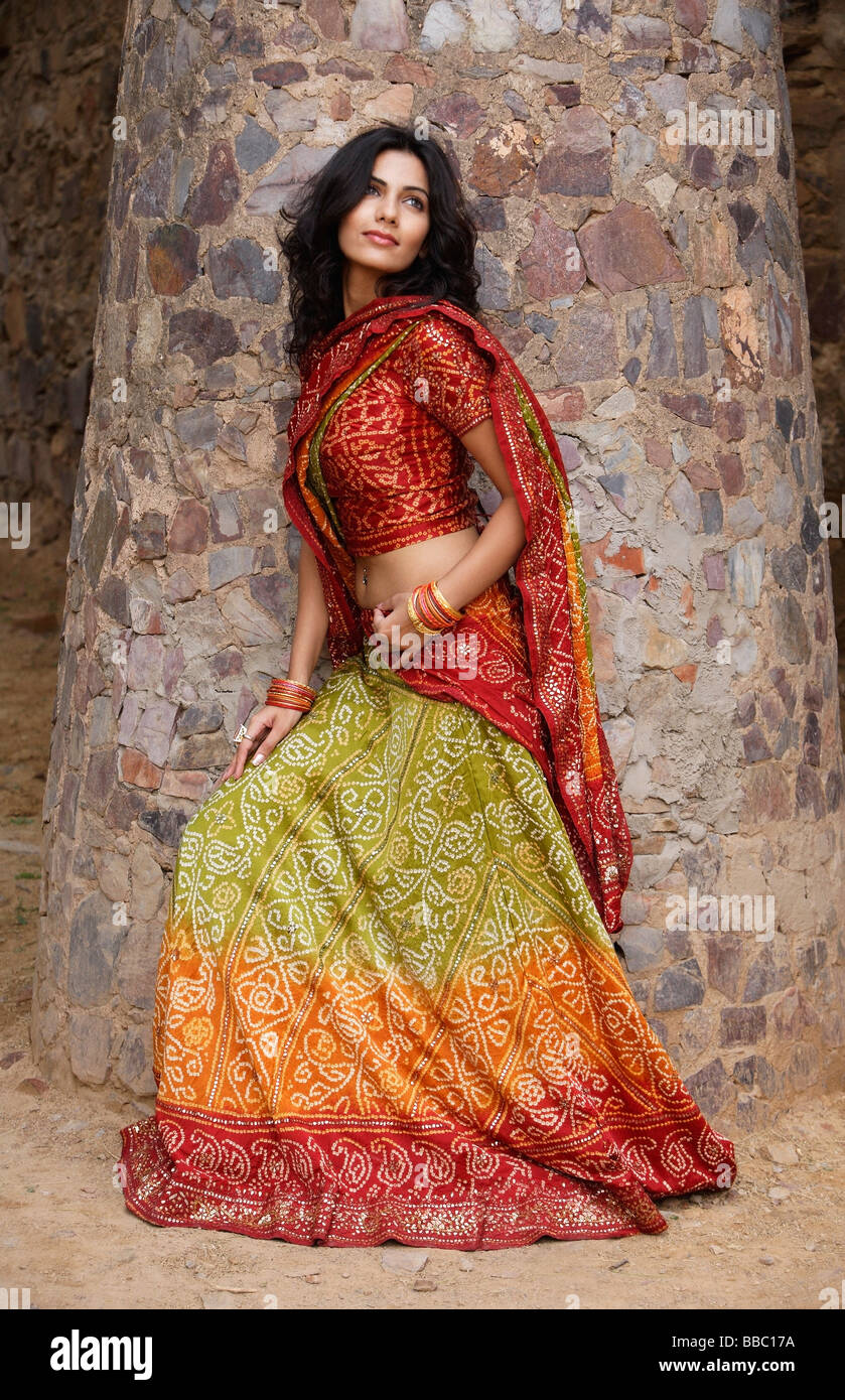 young woman in sari, stone pillar Stock Photo