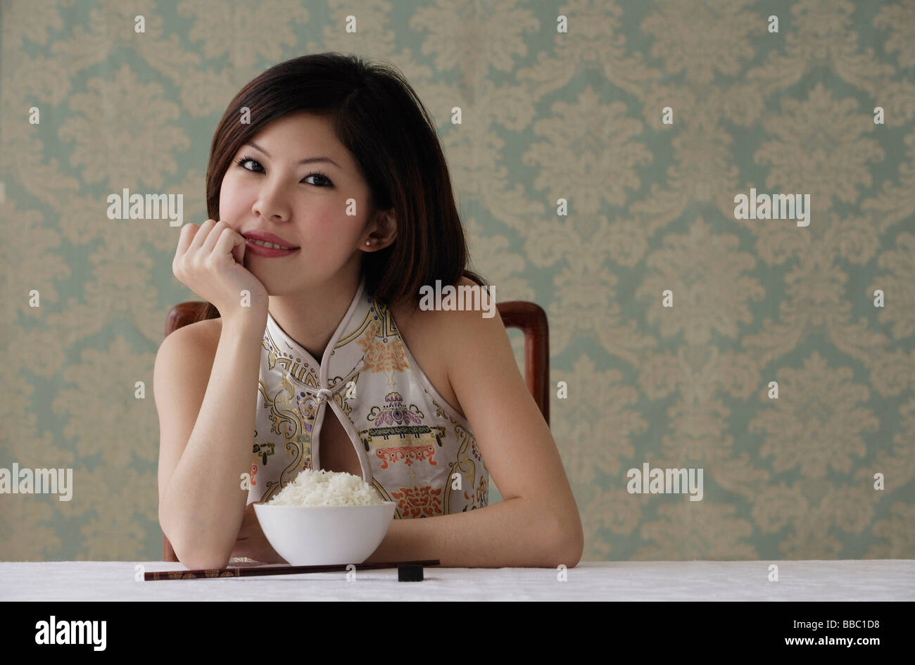 Young woman with bowl of rice Stock Photo