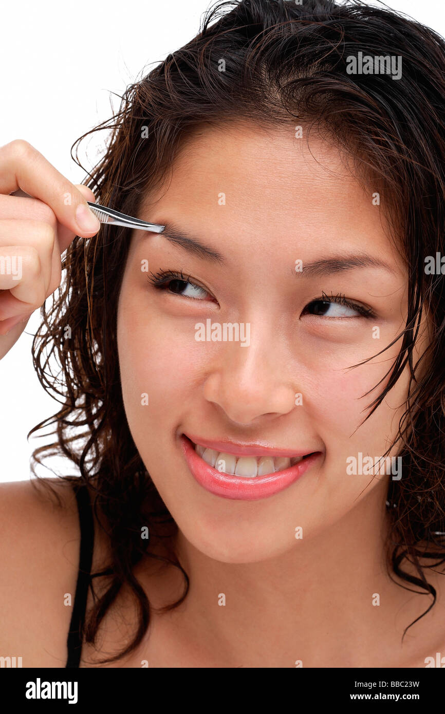 A young woman shapes her eyebrows Stock Photo Alamy
