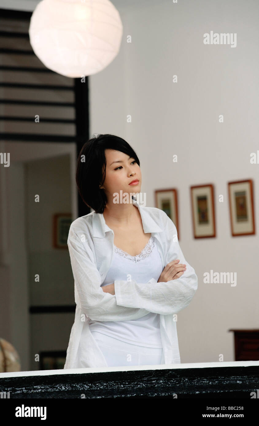 A woman folds her arms in her house Stock Photo Alamy