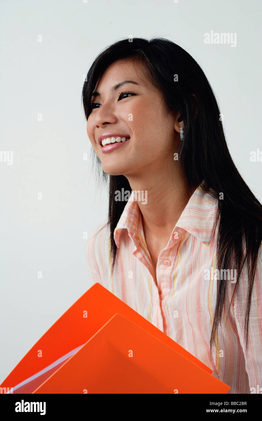 A woman with an orange folder Stock Photo