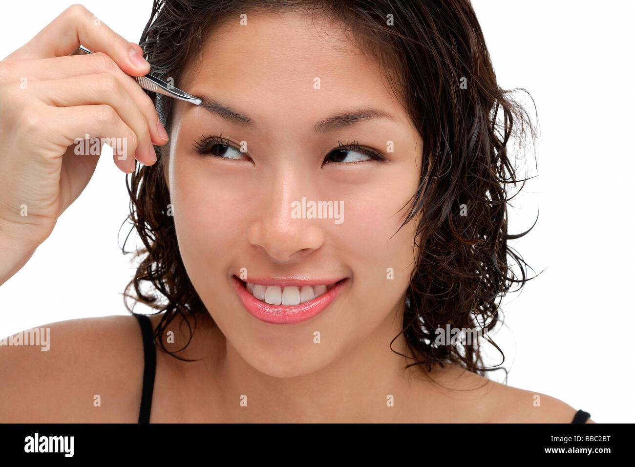 A young woman shapes her eyebrows Stock Photo Alamy