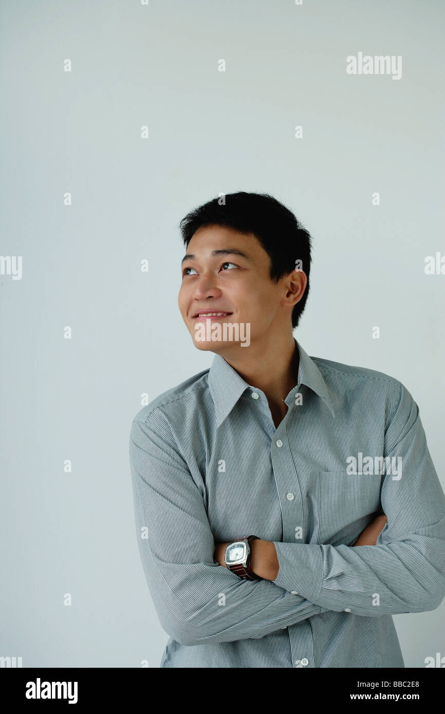 A man crosses his arms and smiles Stock Photo Alamy