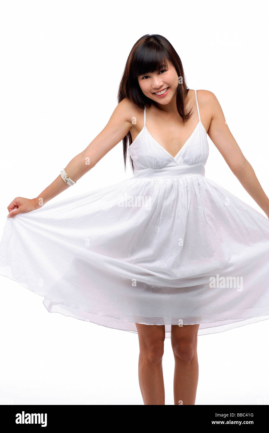 Young girl wearing white dress, smiling Stock Photo Alamy