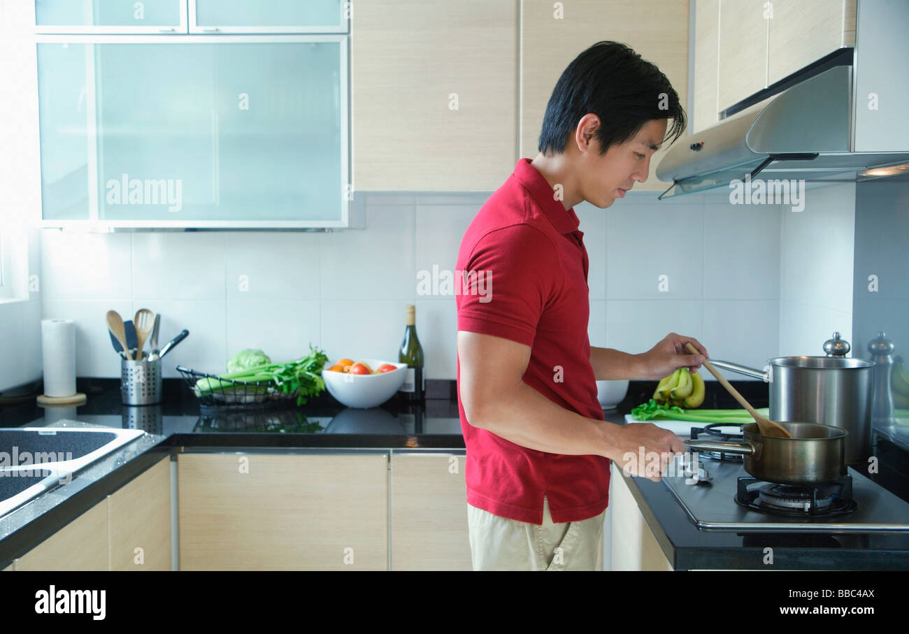 Man Using Kitchen Machine Man cooking in kitchen Stock Photo - Alamy