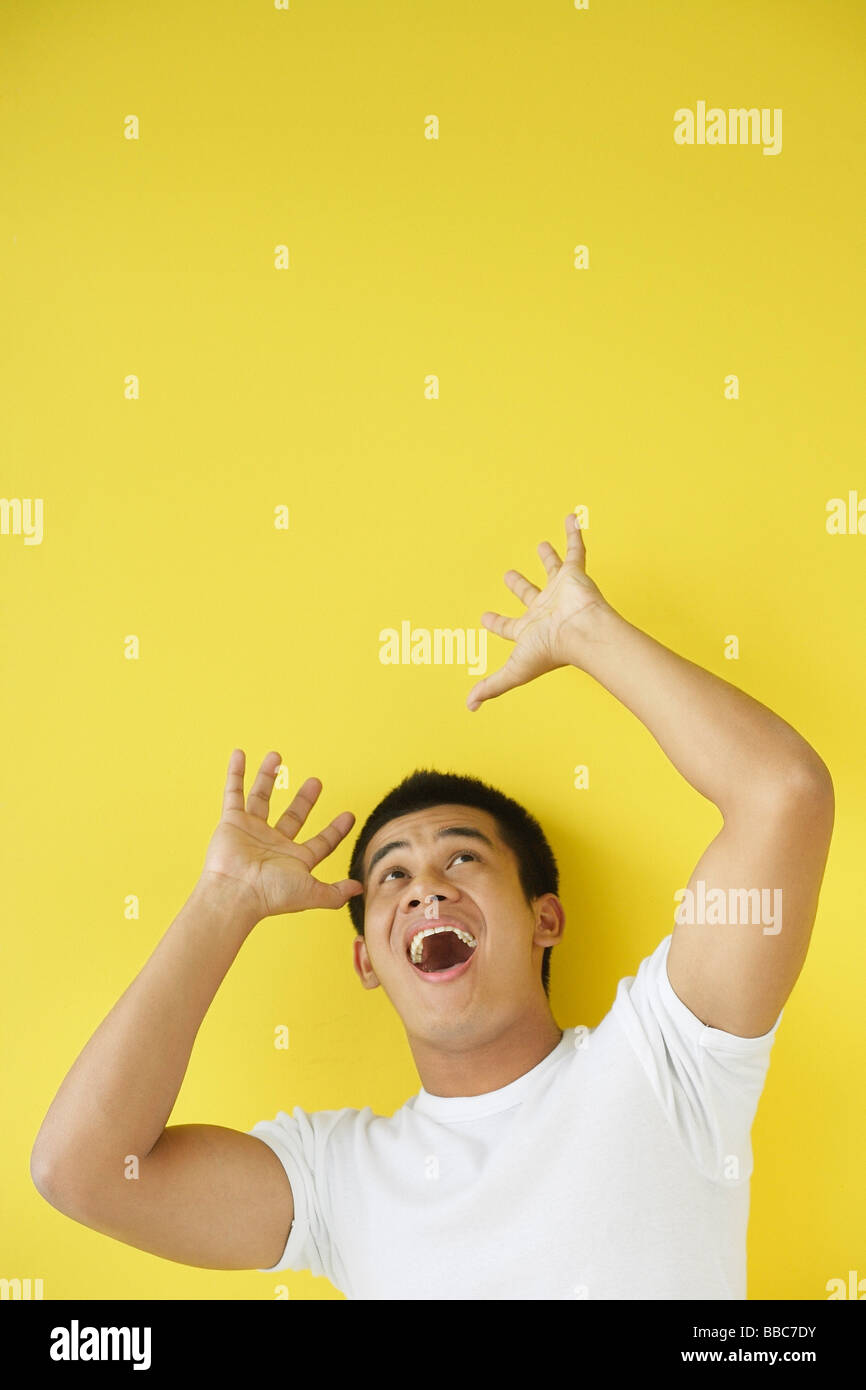 Shocked man hands raised hi-res stock photography and images - Alamy