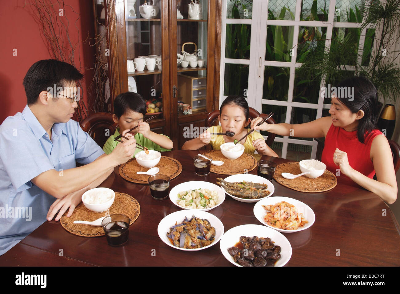 Family of four having dinner at home Stock Photo - Alamy