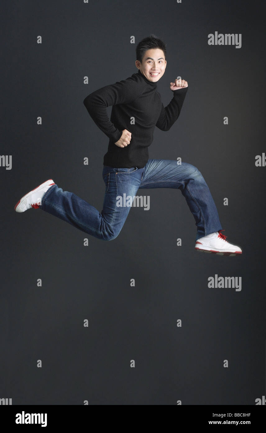 Young black man jumping hi-res stock photography and images - Alamy