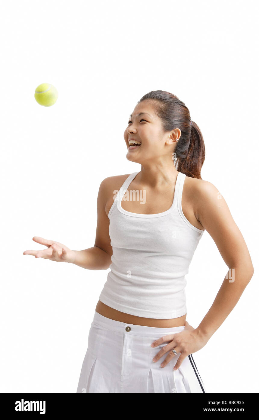 Young woman tossing tennis ball, hand on hip Stock Photo Alamy