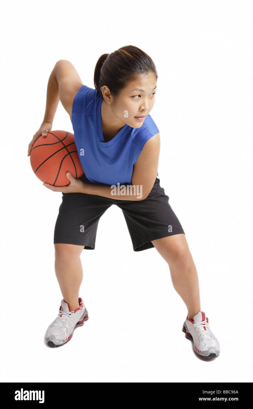 Young woman playing basketball Stock Photo - Alamy