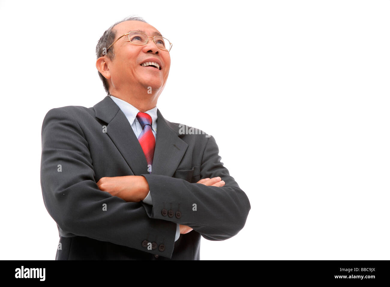 Businessman looking away, arms crossed Stock Photo - Alamy
