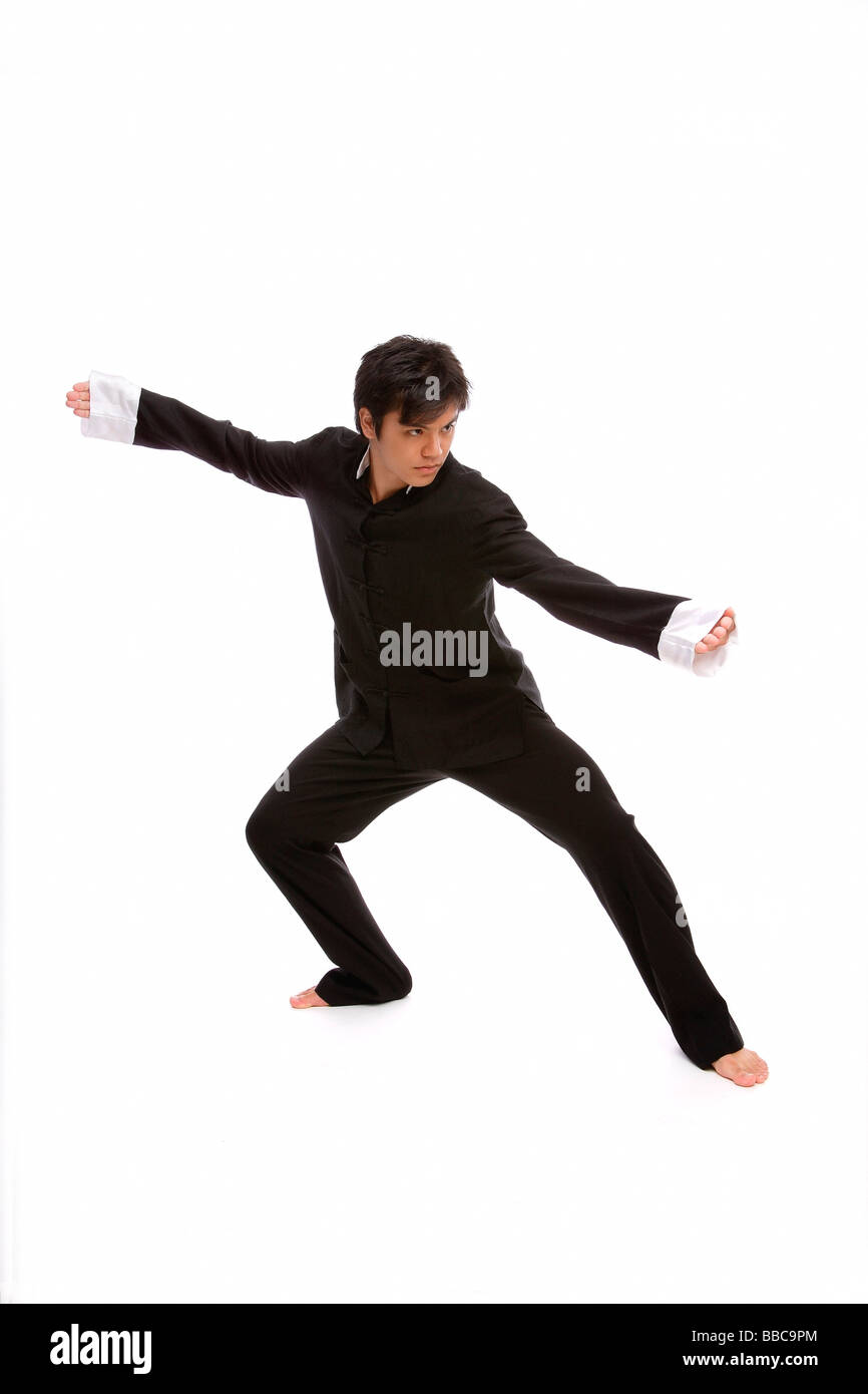 Young man practicing martial arts in studio Stock Photo - Alamy