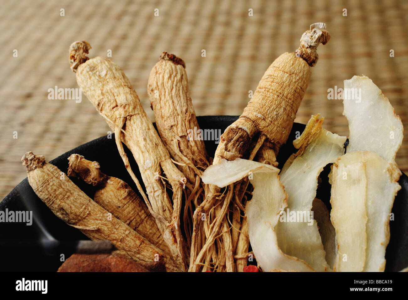 Bowl filled with Chinese medicinal herbs, close-up Stock Photo