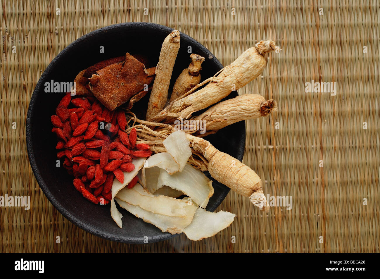 Bowl filled with Chinese medicinal herbs, high angle view Stock Photo