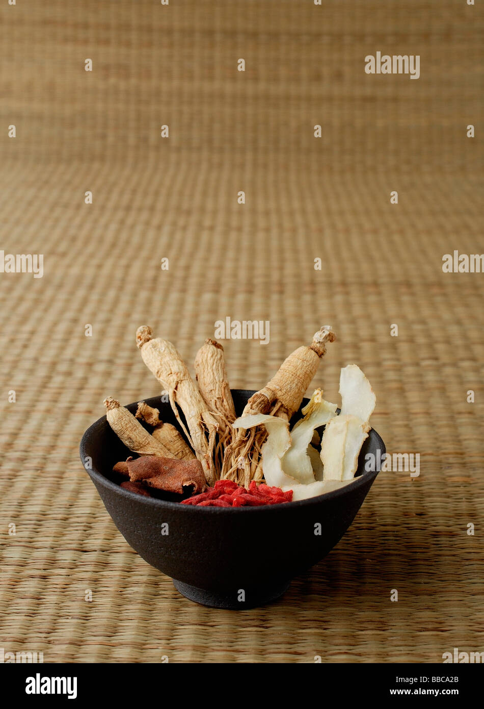 Bowl filled with Chinese medicinal herbs, still life Stock Photo