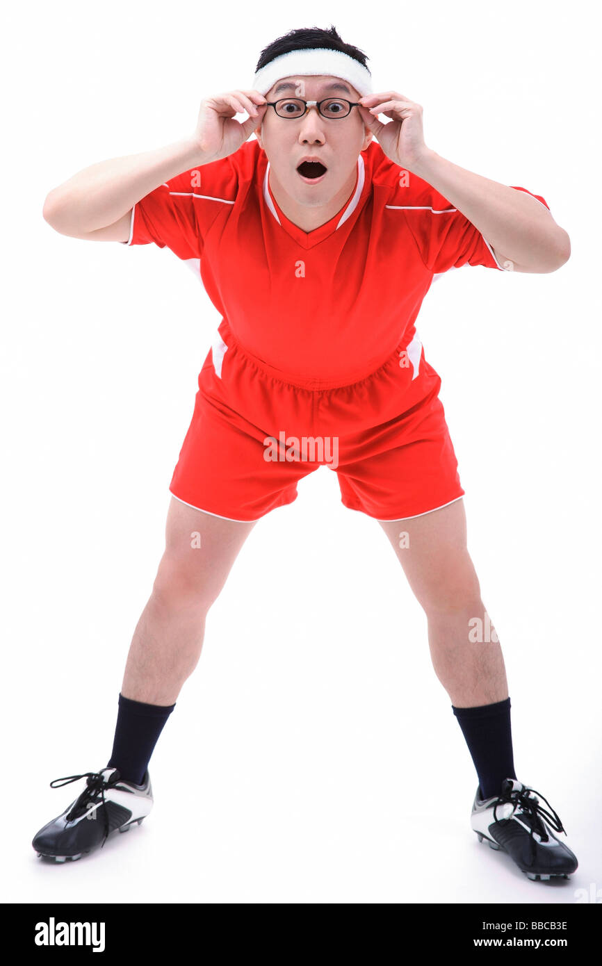 Man in soccer uniform, adjusting glasses Stock Photo Alamy