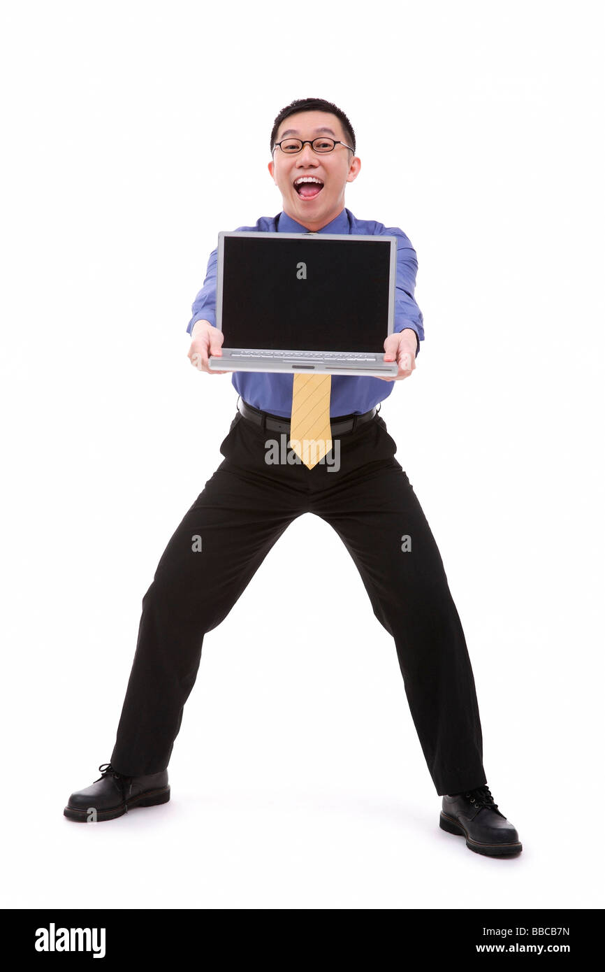 Businessman carrying laptop, portrait Stock Photo