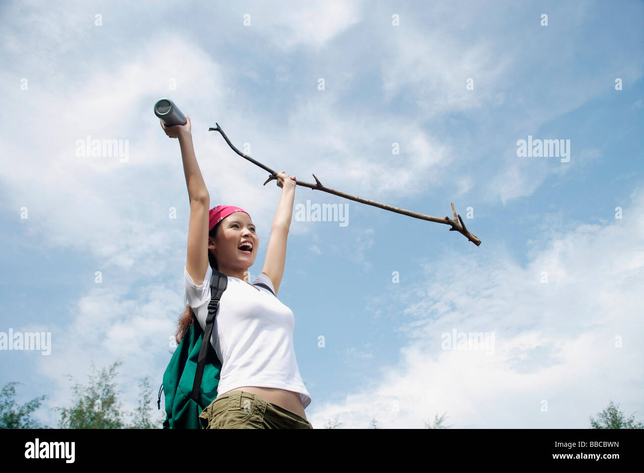 Female hiker, holding hiking stick in air, smiling Stock Photo - Alamy