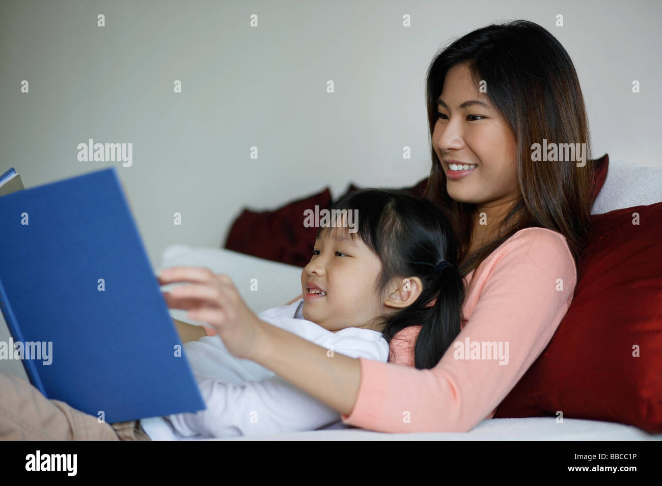 Mother and daughter reading a book Stock Photo