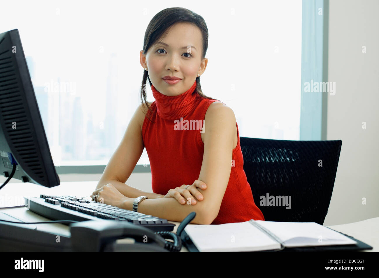 https://c8.alamy.com/comp/BBCCGT/female-executive-sitting-at-office-desk-portrait-BBCCGT.jpg