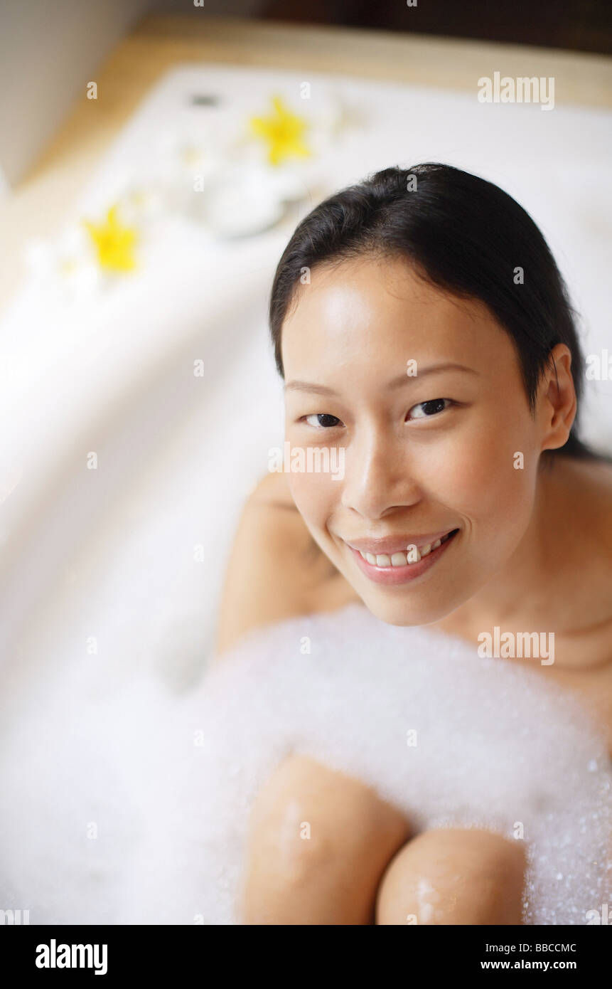 Woman in bathtub, smiling at camera Stock Photo Alamy