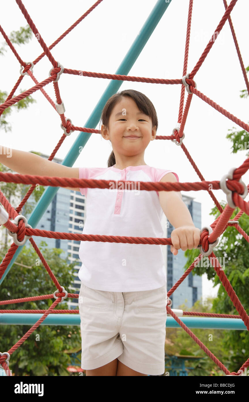 Girl on jungle gym Stock Photo - Alamy