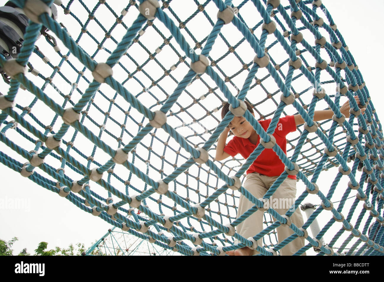 Young boy crawling through net tunnel Stock Photo Alamy