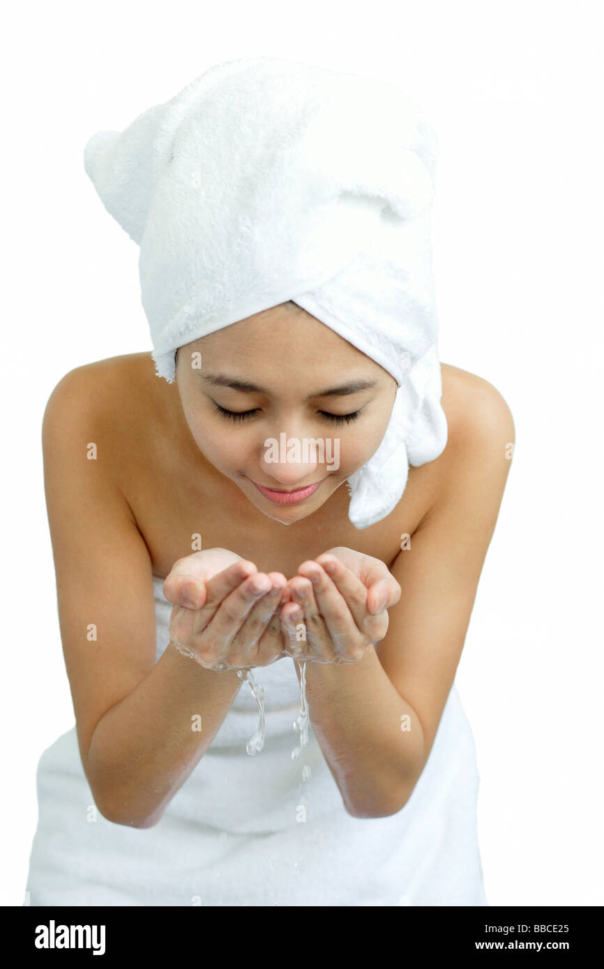 Woman washing her face, holding water in cupped hands Stock Photo Alamy