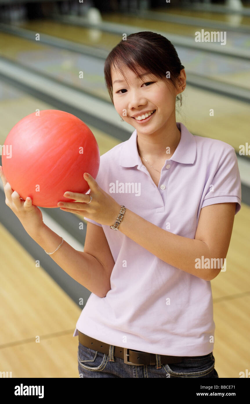 Woman at bowling alley with bowling ball Stock Photo Alamy