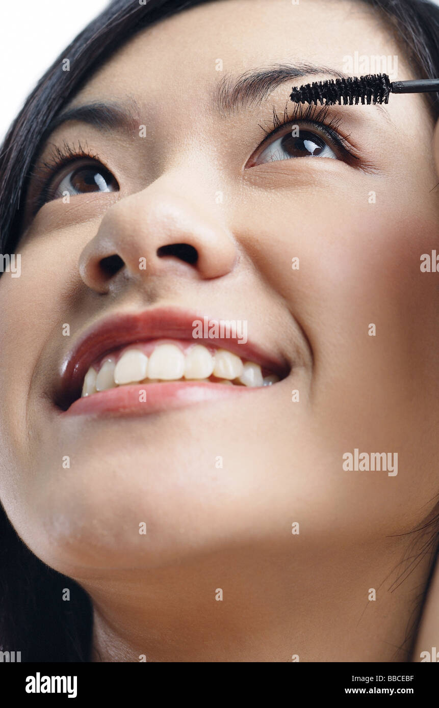 Woman applying mascara Stock Photo Alamy