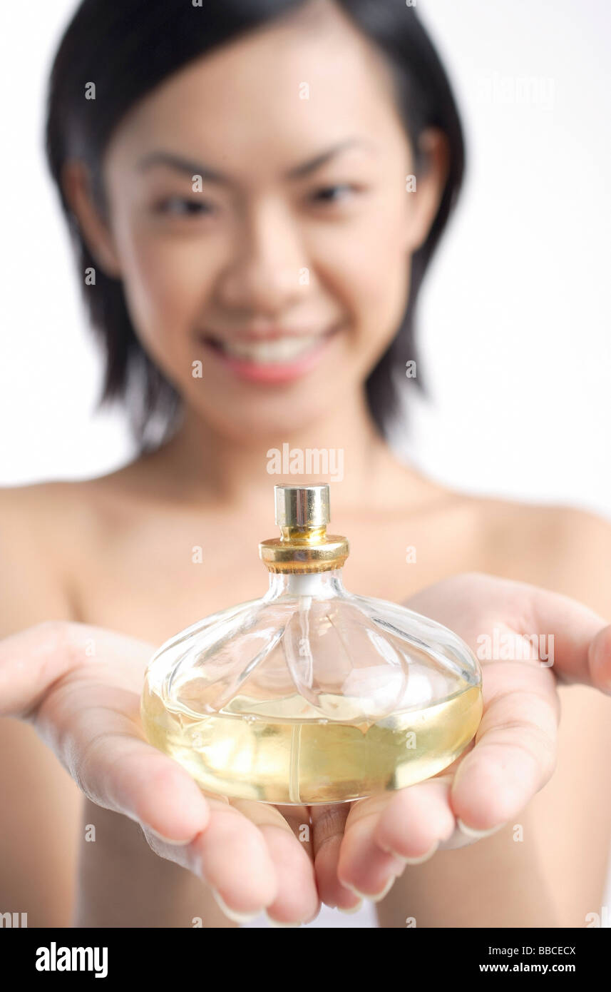 Woman holding perfume bottle Stock Photo Alamy