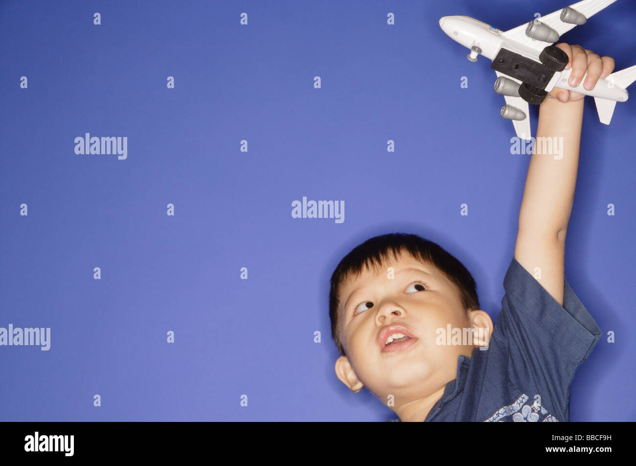 Young boy playing with toy airplane Stock Photo - Alamy