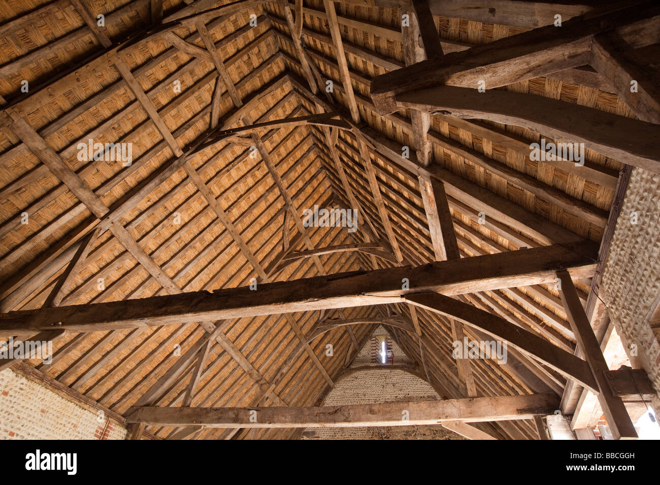 UK England Norfolk Waxham historic medieval stone barn interior roof timbers Stock Photo