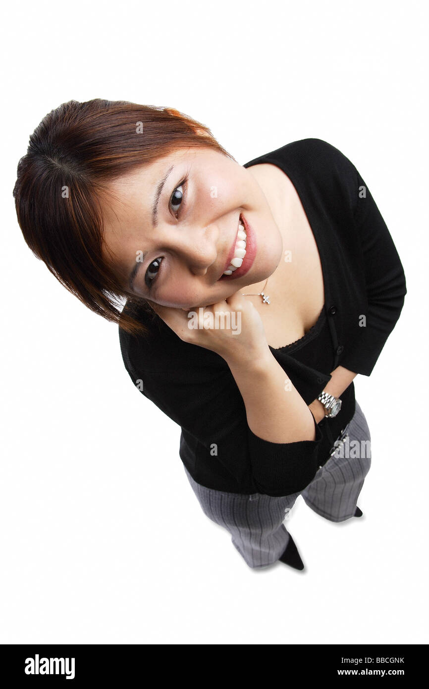 Woman standing, hand on chin, looking up at camera Stock Photo - Alamy