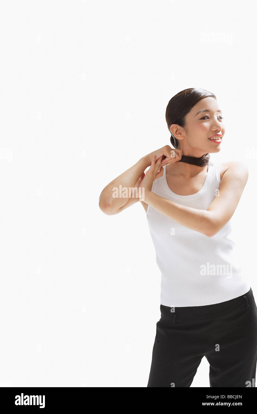 Pulling ponytail around her neck hires stock photography and images