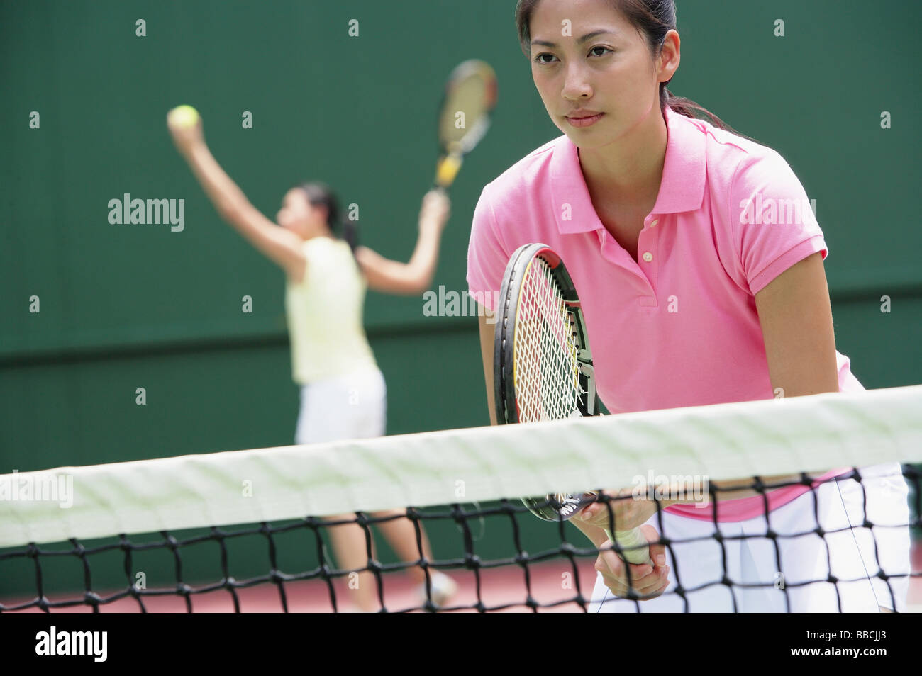 Women with tennis rackets, playing tennis Stock Photo
