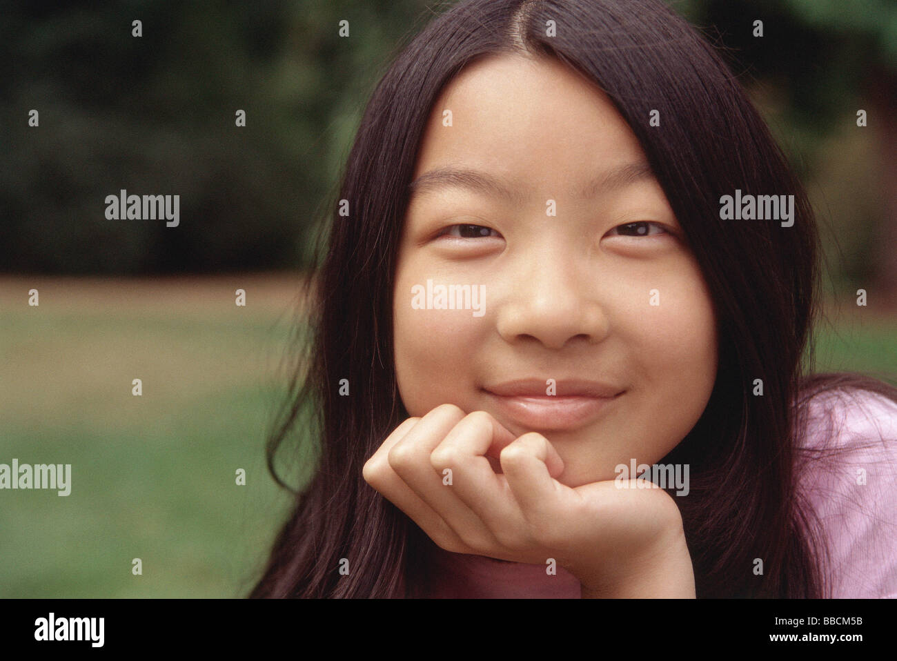 Girl with hand on chin Stock Photo