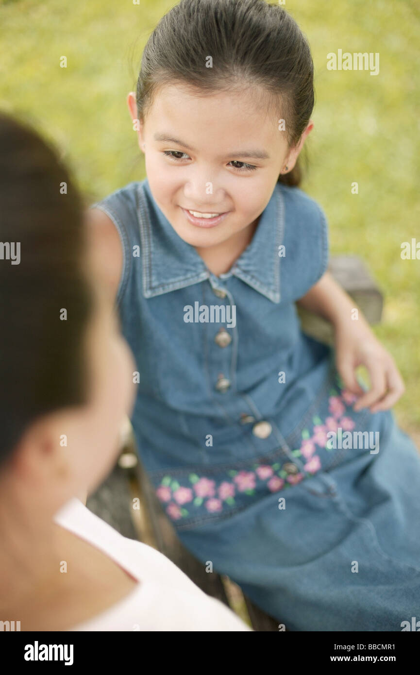 Young Girl Sitting Down With Her Mother Stock Photo Alamy