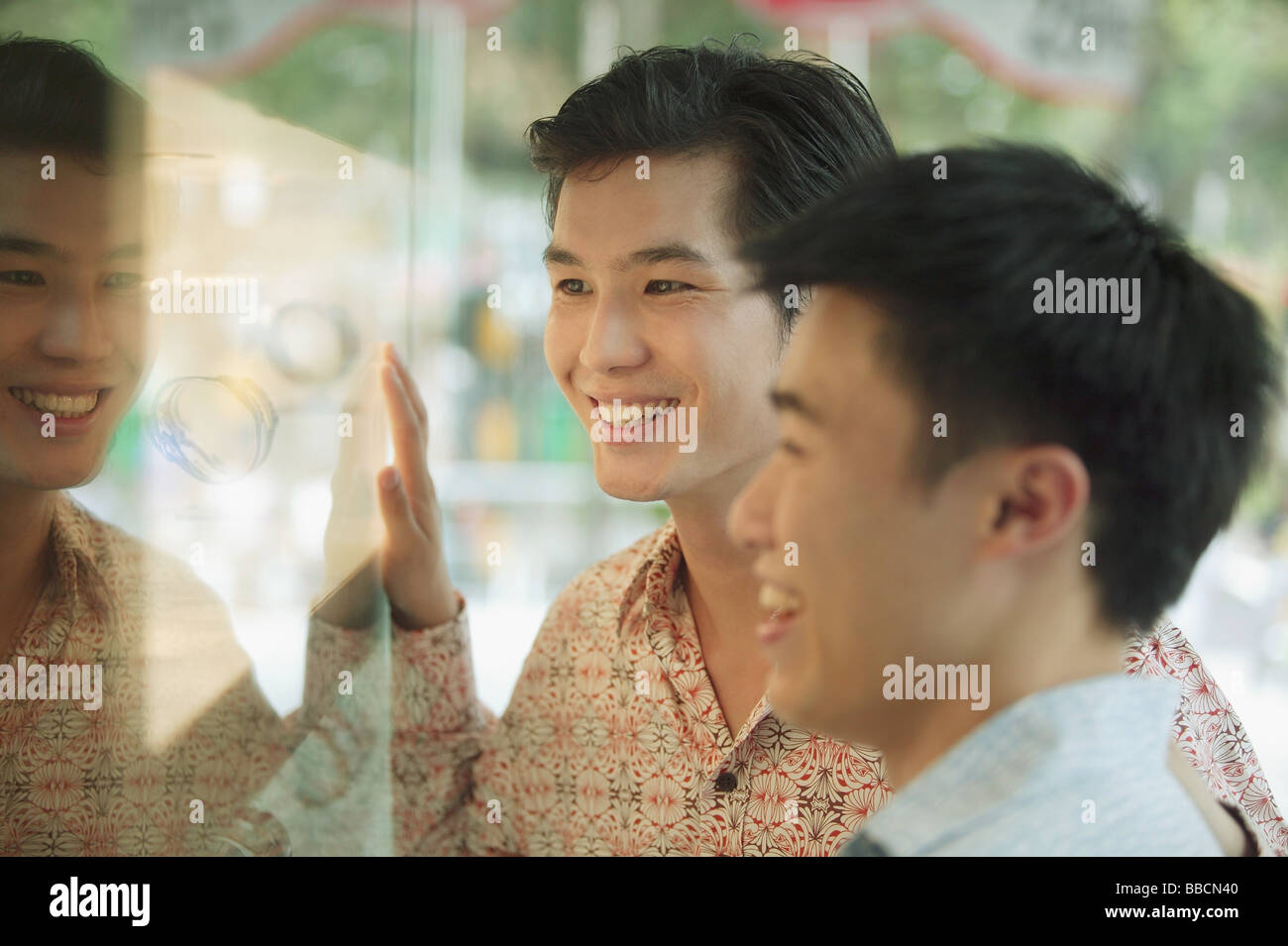 Two men in front of shop window Stock Photo - Alamy