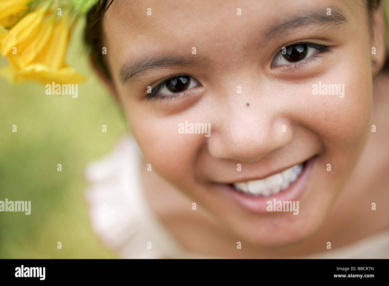 Young girl smiling, looking at camera Stock Photo - Alamy