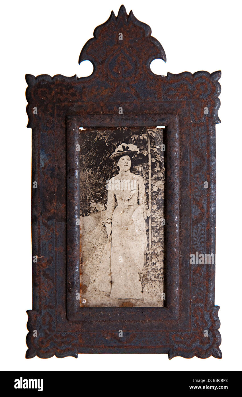 Antique metal Victorian picture frame with photograph  dated circa 1900 in poor condition and requiring restoration UK Stock Photo