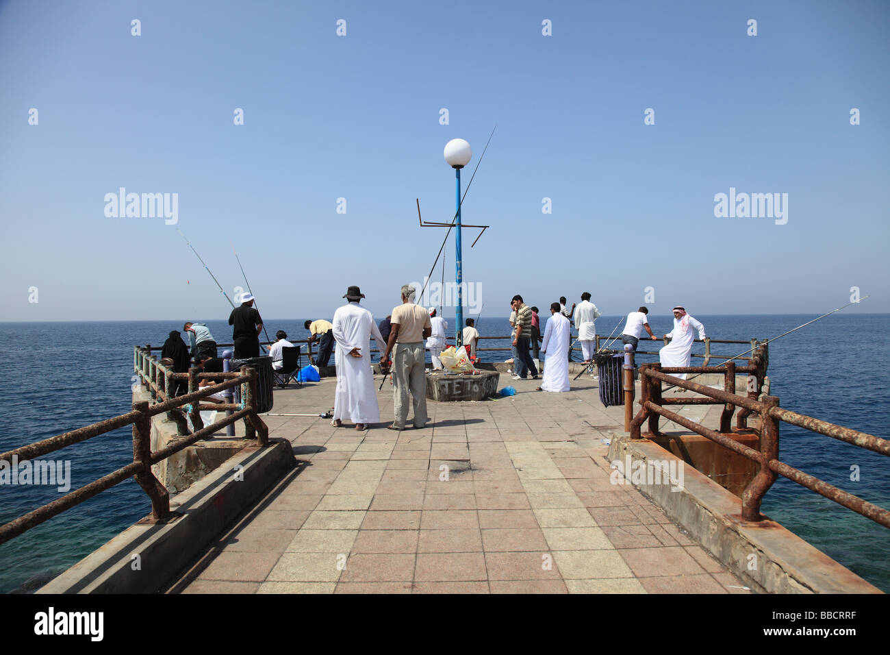 Men fishing from jetty Jeddah Saudi Arabia Stock Photo Alamy