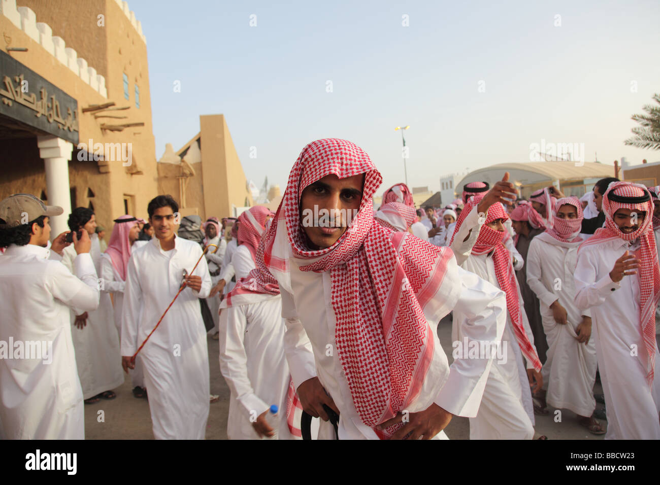 Men dance in traditional dress Janadriya Festival Riyadh Saudi Arabia Stock Photo