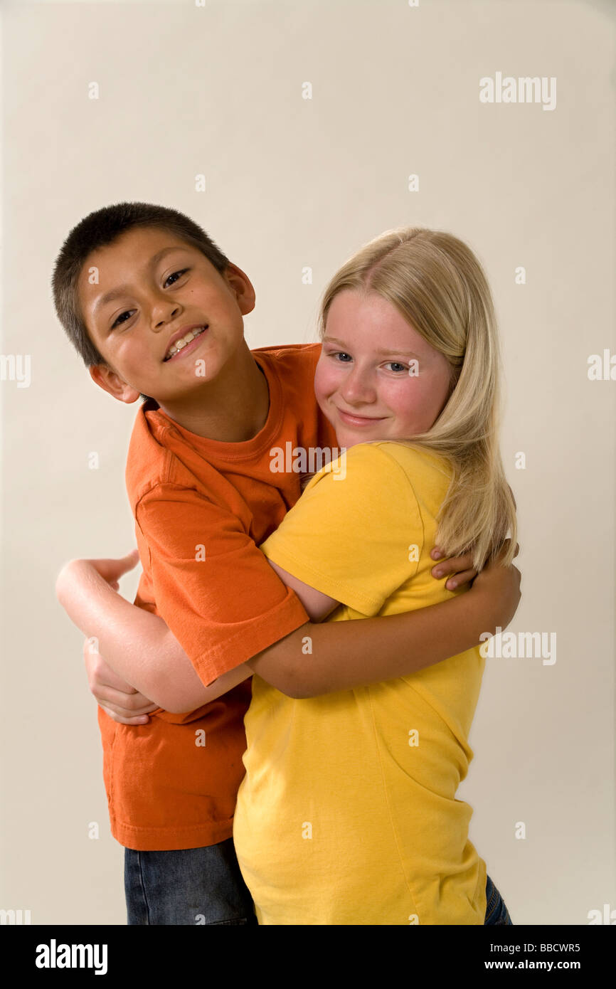 diverse diversity multicultural Portrait young 11-12 year old adopted 7-9 year olds adopted Hispanic younger brother interracial inter racial having fun Stock Photo