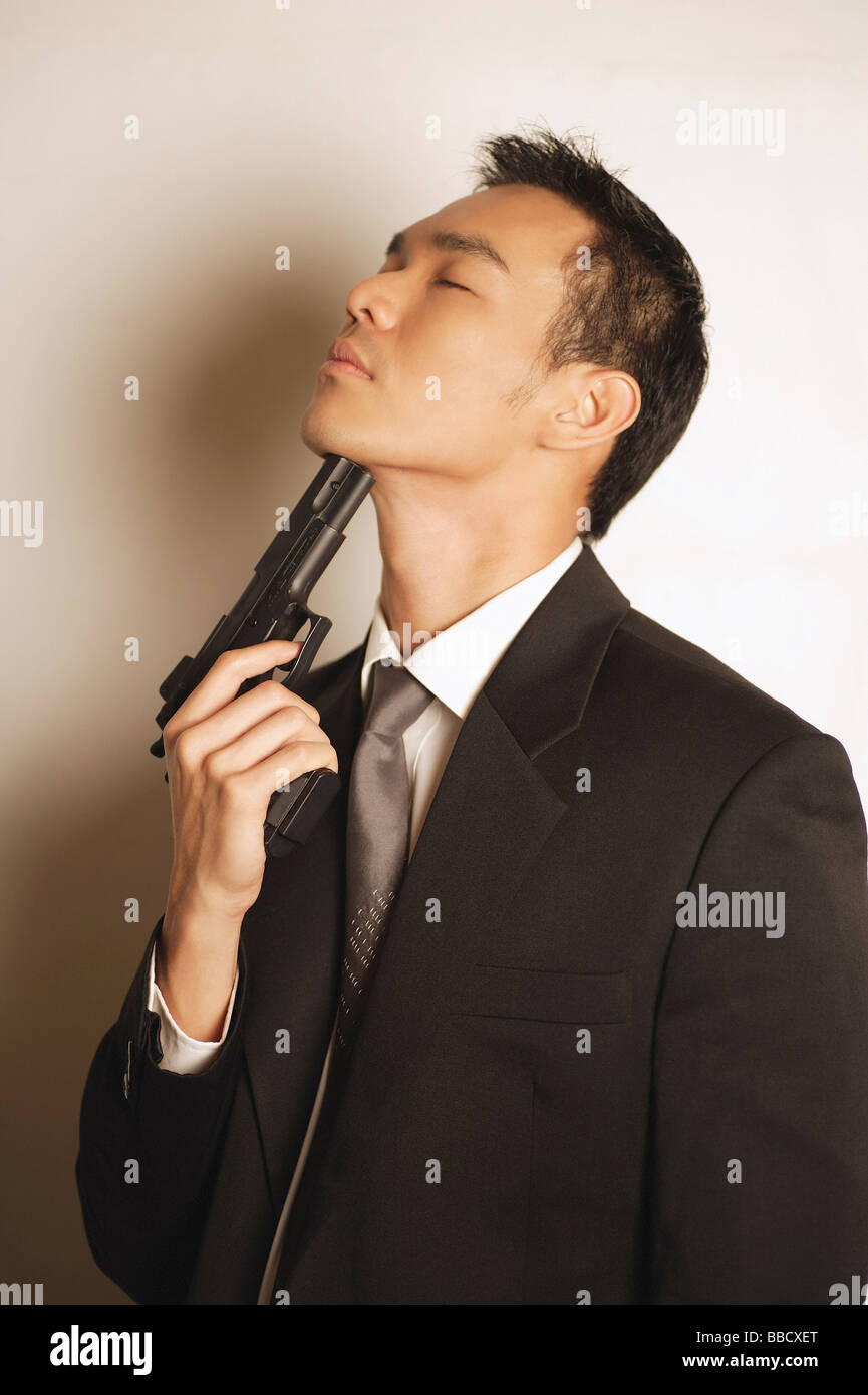 Serious man holding pistol pointing hires stock photography and images