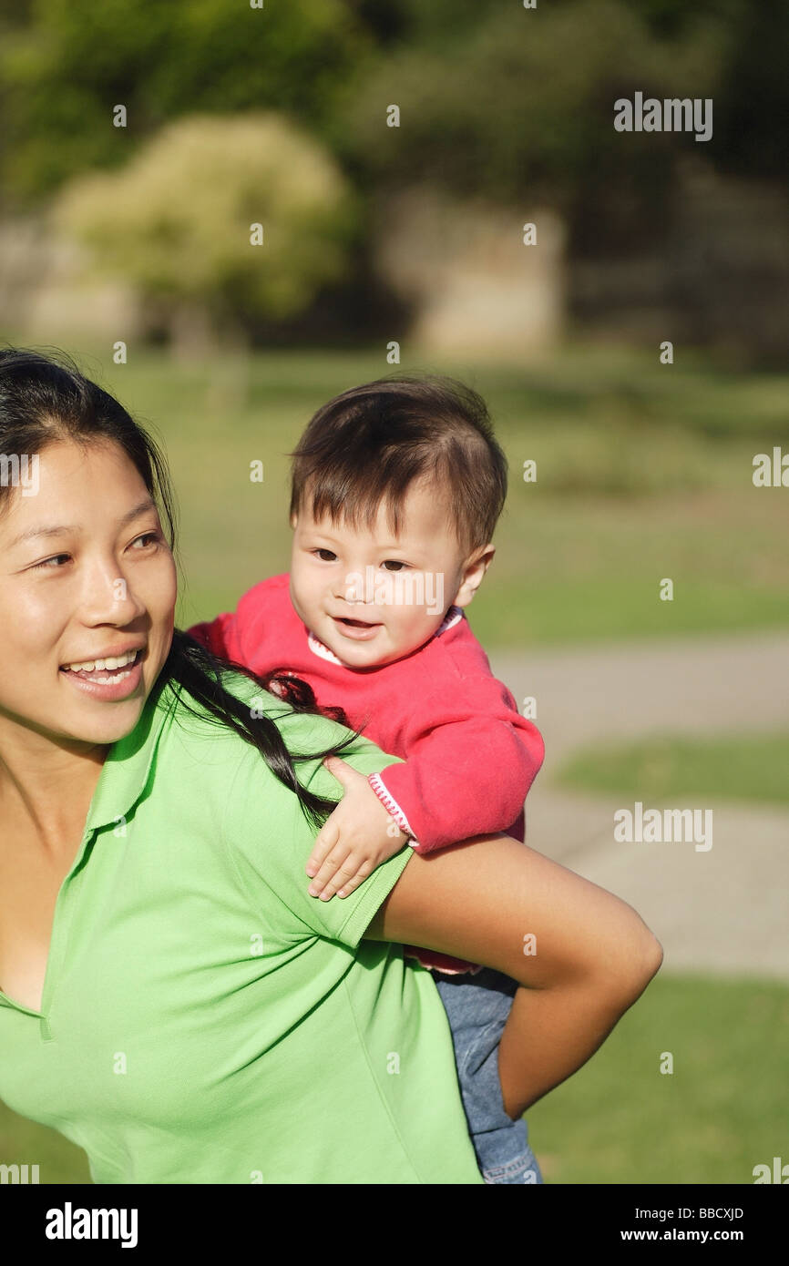 Black woman carrying child on back hires stock photography and images