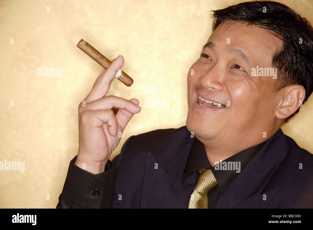 Man with cigar looking away, smiling Stock Photo