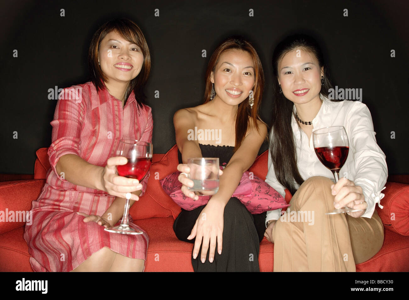 Women with drinks, looking at camera Stock Photo - Alamy
