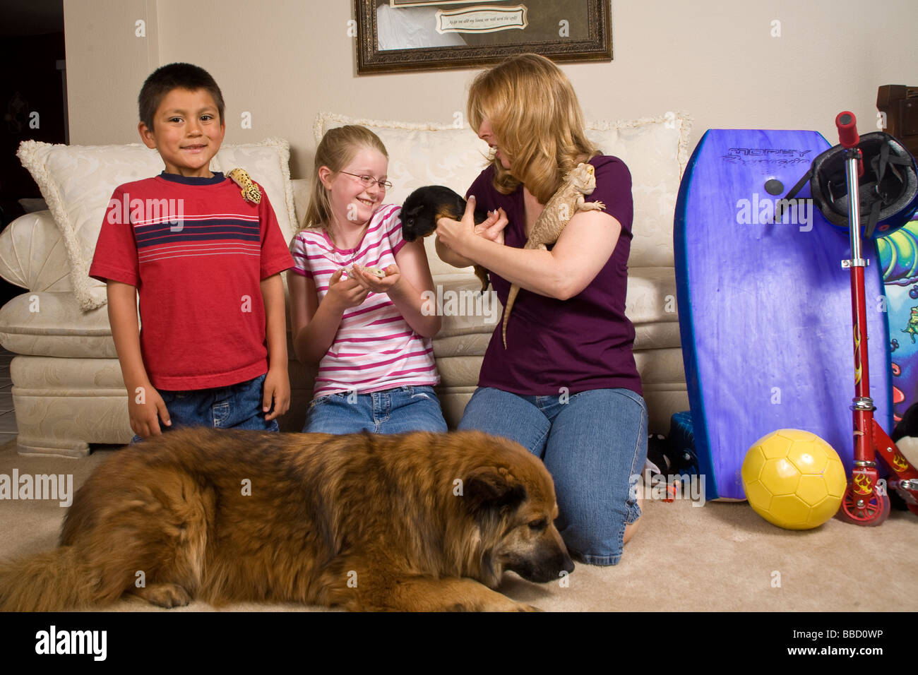 Family with adopted foster child Mexican Hispanic boy adopts pets front humorous humor funny confusion chaos MR  © Myrleen Pearson Stock Photo